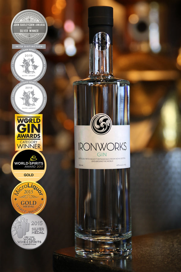 Single bottle of gin with simple elegant label and column of seven medals awarded between 2015 -2019